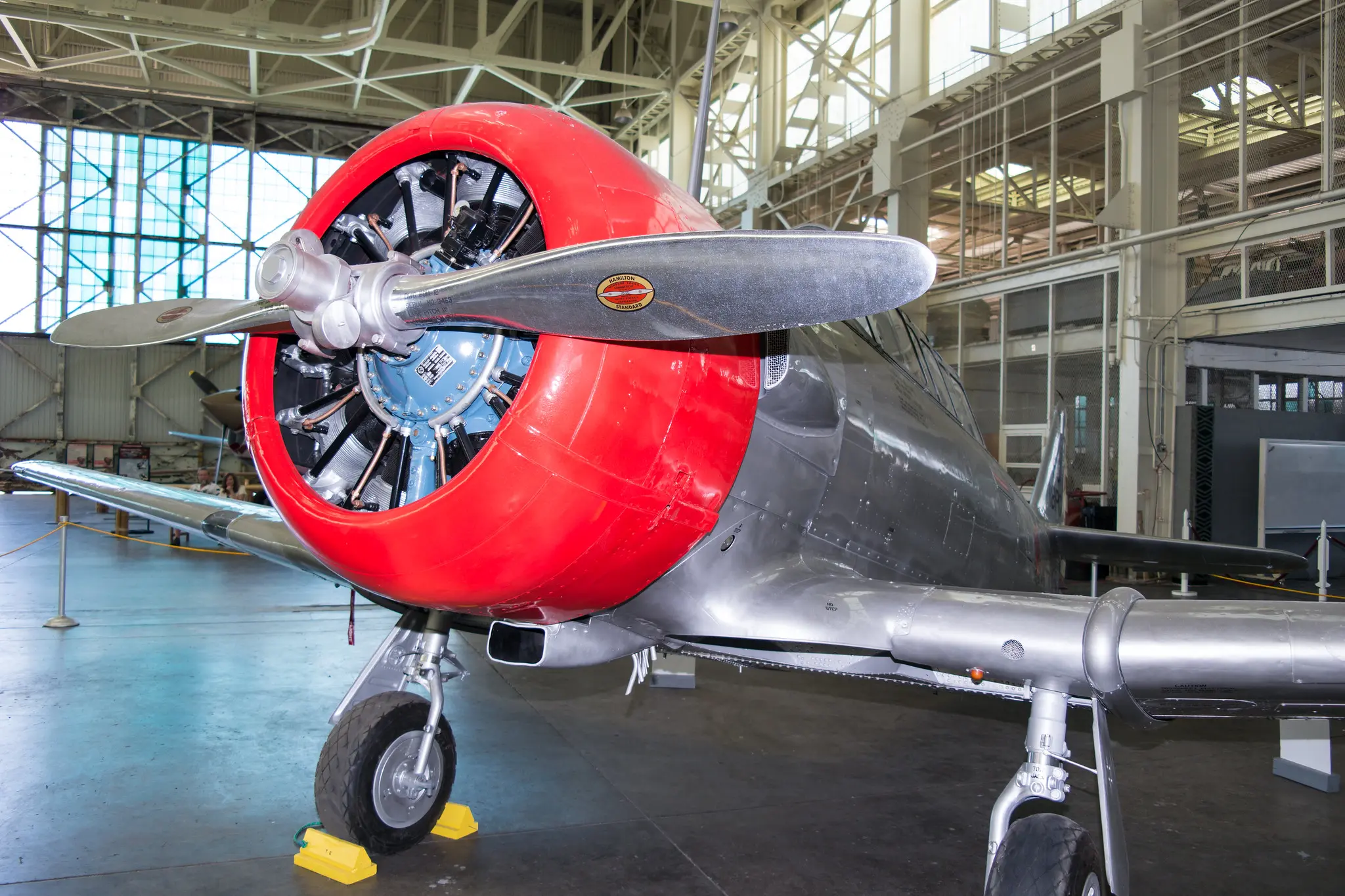 Close up photograph of T-6 aircraft displayed inside of a hangar.